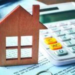 A wooden house on a calculation sheet and a calculator